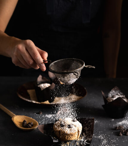 powdered sugar dusted on chocolate chip muffins