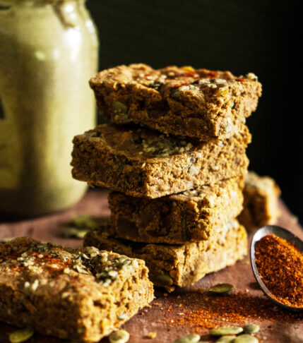 a stack of savory vegan protein bars with pumpkin seeds